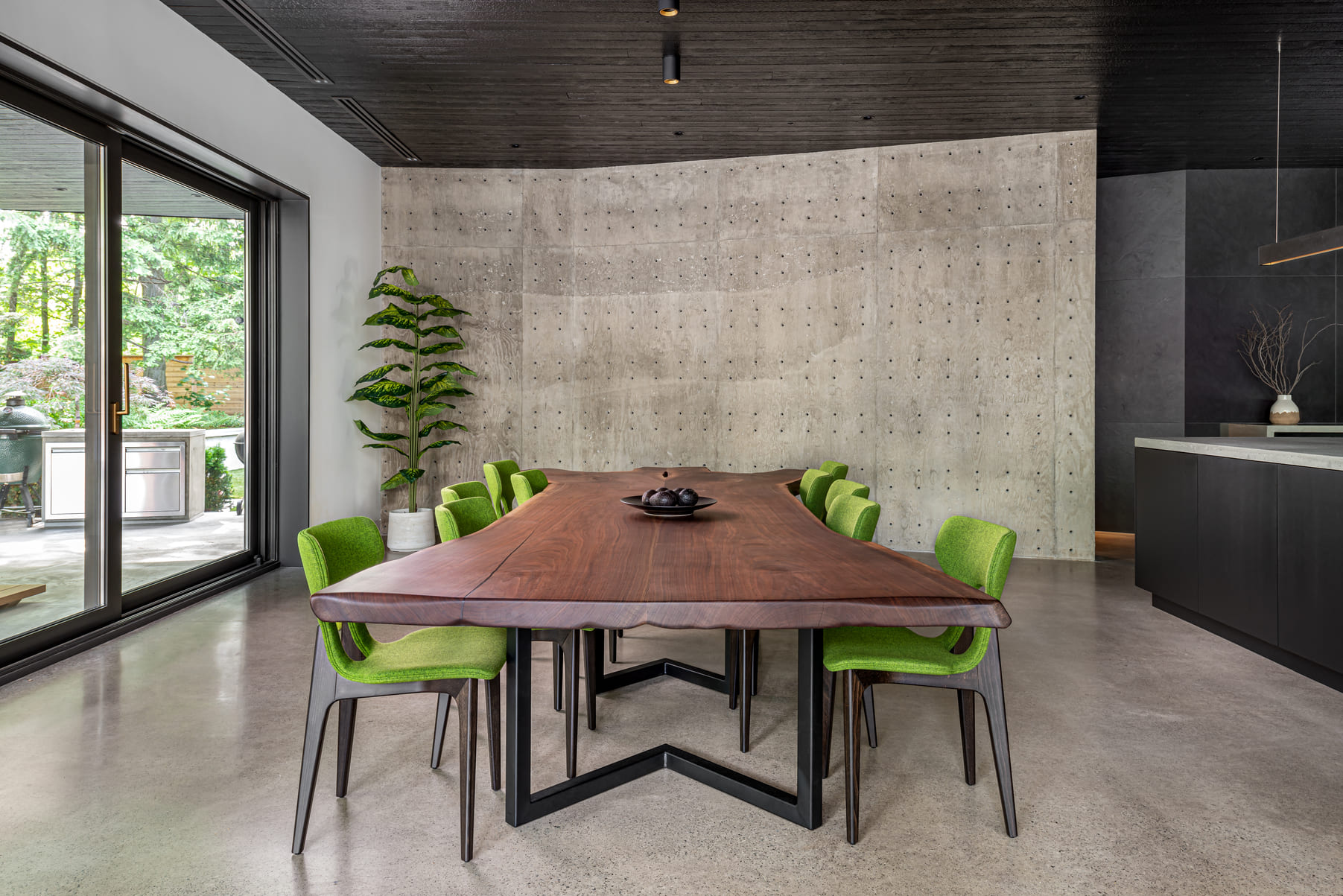 Contemporary custom home design featuring concrte slabs and a wood grain kitchen table.