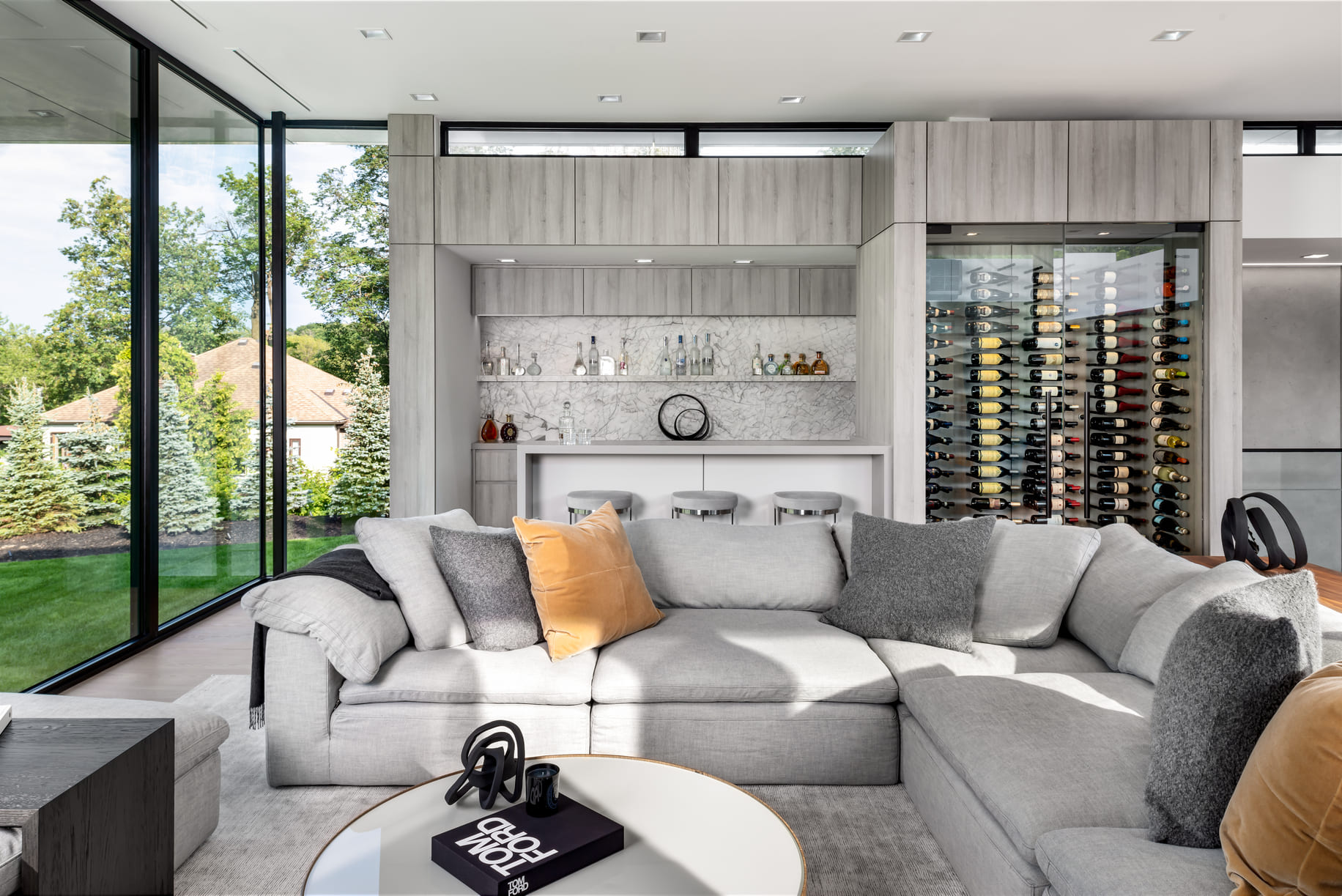 Large open concept living space featuring a custom wine bottle inspired and bar area.